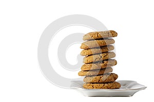A stack of gingerbread cookies on a white plate isolated on white background with copy space