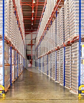 Stack of glass box on pallets places on rack inside distribution warehouse