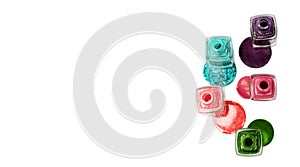 Stack of glitter nail polish: aquamarine, red, pink, purple and green isolated on white background