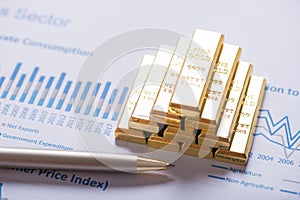 Stack of gold bar on business analysis graph background