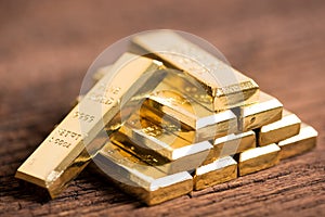 Stack of gold bar on wood background