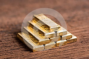 Stack of gold bar on wood background