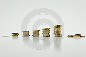 Stack of gold coins, six rows on white background with clipping path. Growing and saving money concept