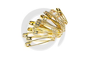 Stack of gold colored safety pins