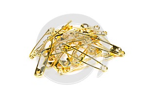Stack of gold colored safety pins