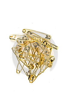 Stack of gold colored safety pins