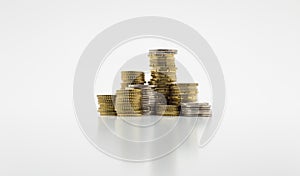 Stack of gold and silver coins on white background with clipping path. Growing and saving money concept