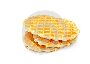 A stack of golden round waffles isolated on white background