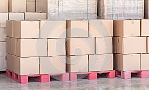 Stack of goods carton boxes on red pallet at logistics warehouse