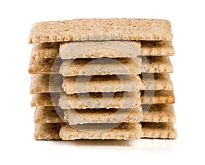 Stack of grain crispbreads on white background