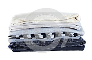Stack gray winter clothes isolated on white background.