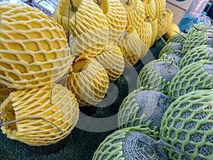 stack of green melon and yellow watermelon
