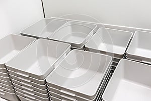 Stack of grey plastic trays arrangement for background.