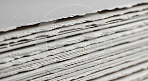 Stack of handmade paper with textured deckled edges