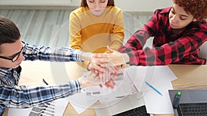 Stack of hands. Business startup teamwork unity concept. Diverse team putting their hands together top view. Young