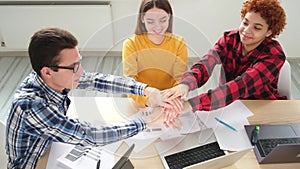 Stack of hands. Business startup teamwork unity concept. Diverse team putting their hands together top view. Young