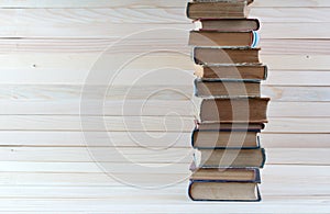 Stack of hardback books on wooden table. Back to school.