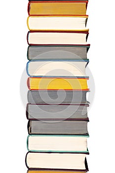 Stack of hardcover books on bookshelf. Close up view of hardback books isolated on white background