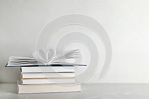 Stack of hardcover books on table against white background