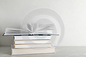 Stack of hardcover books on table against white background