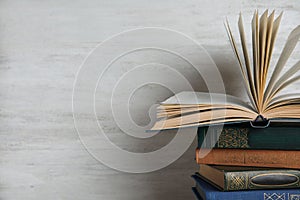 Stack of hardcover books on white background. Space for text