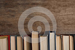 Stack of hardcover books on wooden background