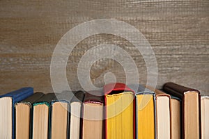 Stack of hardcover books on wooden background