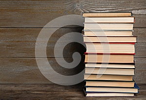 Stack of hardcover books on wooden background