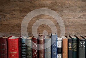 Stack of hardcover books on wooden background