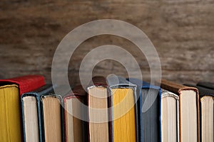 Stack of hardcover books on wooden background