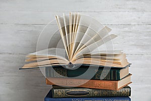 Stack of hardcover books on wooden background