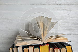 Stack of hardcover books on wooden background