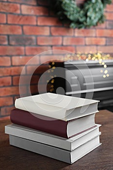 Stack of hardcover books on wooden table indoors