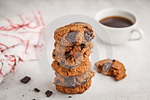 Stack of healthy vegan cookies with chocolate, white background.