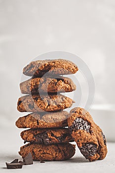 Stack of healthy vegan cookies with chocolate, white background.