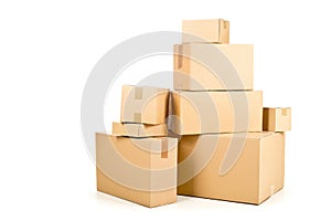 Stack or heap of brown carton cardboard boxes over white, freight, deilvery or shipping concept