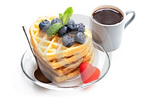 Stack of heart shaped waffles with fresh blueberry isolated on white