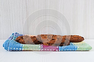 Stack of Home Bakes Chunky Chocolate Chip Cookies on Napkin Kitchen Table Glass of Milk in Background