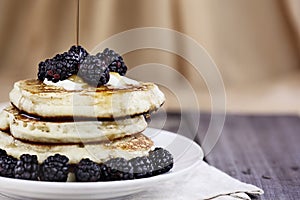 Pancakes Berries and Syrup Being Poured