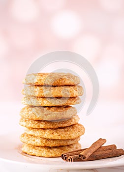 Stack of homemade snickerdoodle cookies with cinnamon sticks