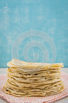 Stack of Homemade Tortillas on Orange Napkin photo