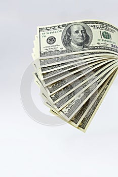 A stack of hundred-dollar bills isolated on a white background