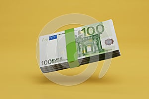 a stack of hundred-dollar bills on a yellow background. 3D render