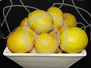 stack of imperfect lemons on black and white background photo