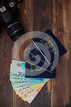 Stack of israeli money bills of 200, 100 shekel and israeli passport