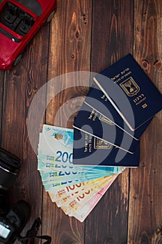 Stack of israeli money bills of 200 shekel and israeli passport