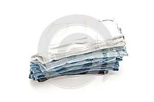 stack of jeans folded on white background