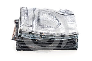 stack of jeans folded on white background