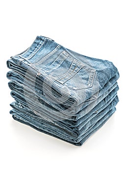 stack of jeans folded on white background