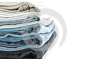 stack of jeans folded on white background